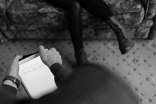 a student taking notes on a tablet