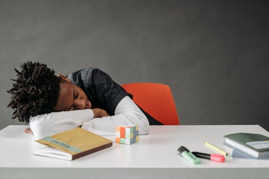 young student sleeping at desk