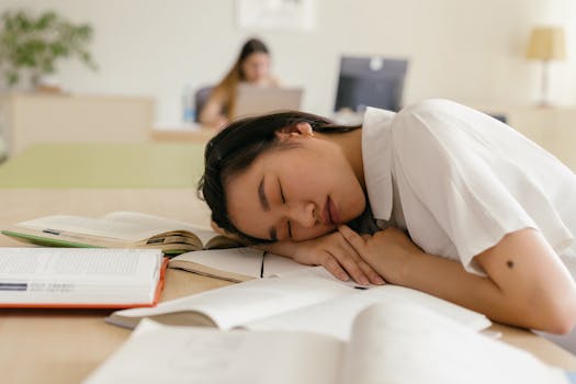 sleeping student with books